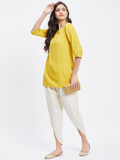 Cream Solid Rayon Tulip Pant with elastic waistband and side pocket.