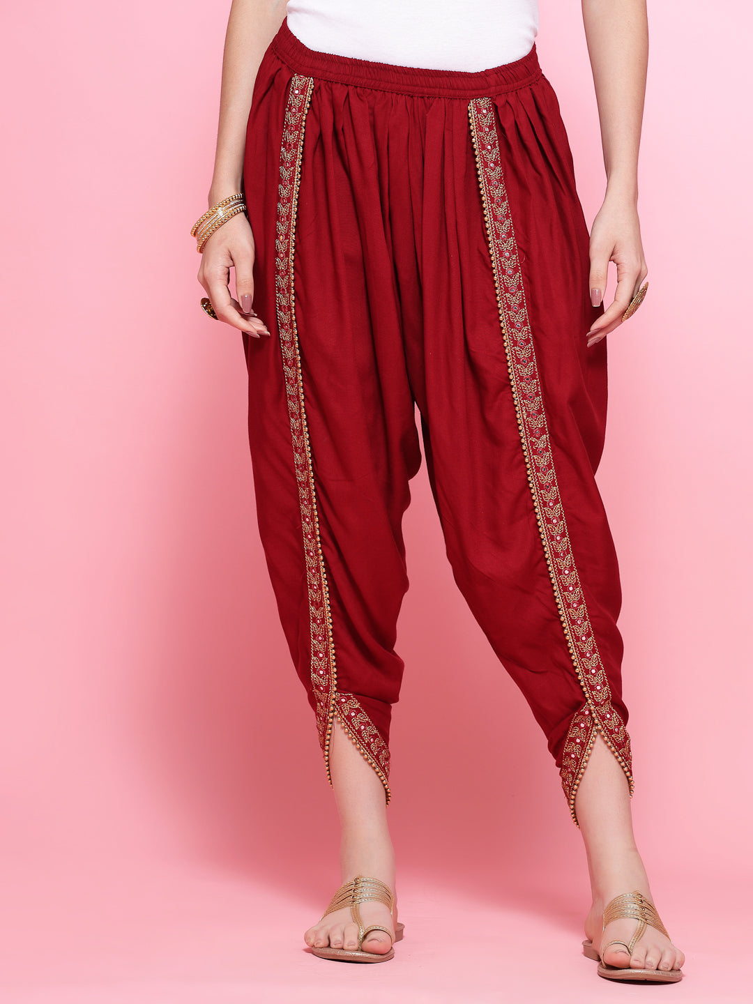 Maroon embroidered rayon dhoti pants with elastic waistband and embellished border.