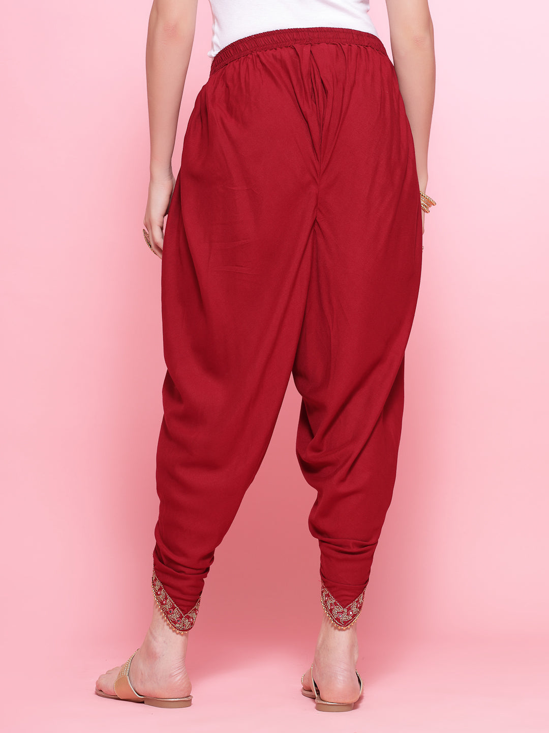Maroon embroidered rayon dhoti pants with elastic waistband and embellished border.