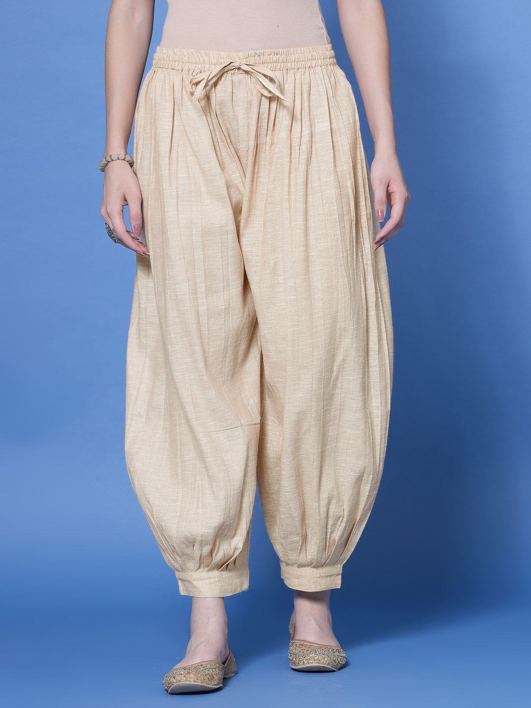 Beige self design cotton loose fit Afghani salwar with elasticated waistband and drawstring.