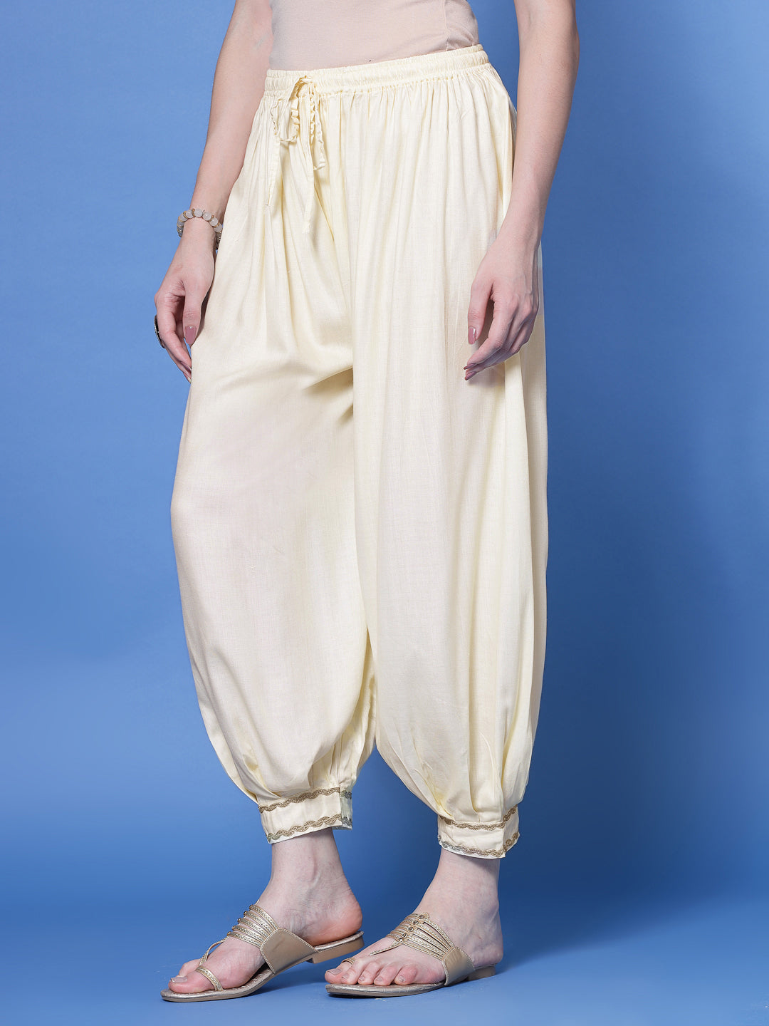 Cream embellished hem loose fit Afghani salwar with elastic waistband and drawstring.