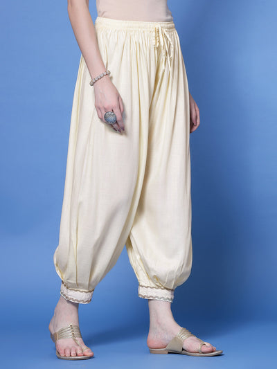 Cream loose fit Afghani salwar with embellished hem and elasticated waistband.