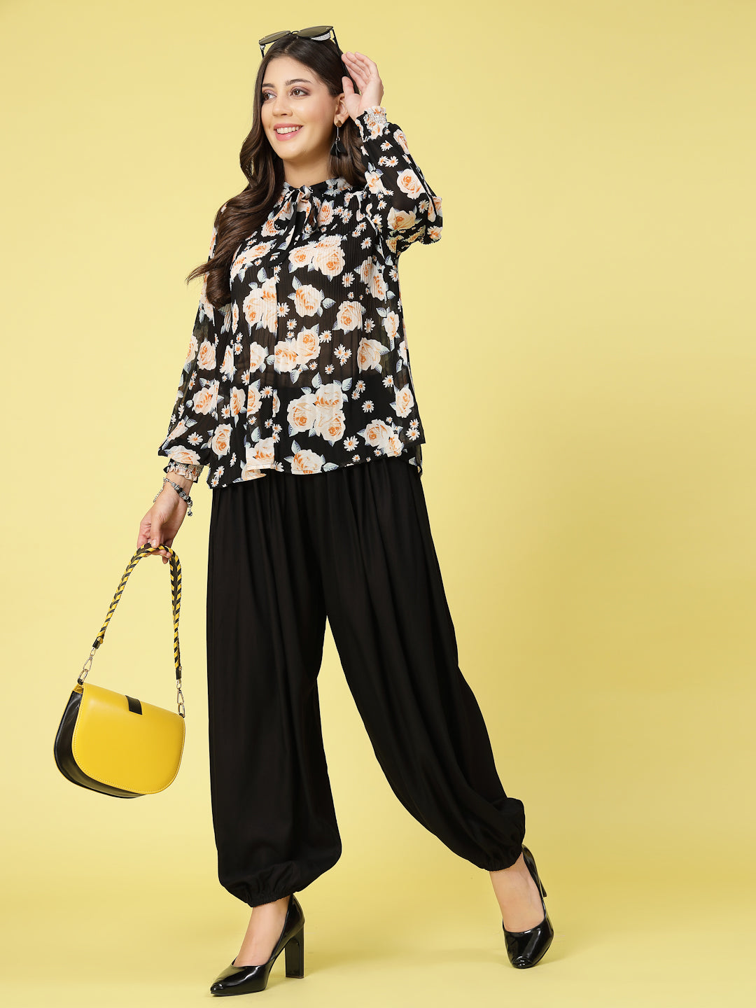 Women wearing black loose fit rayon salwar with pleated detail and elasticated waistband.