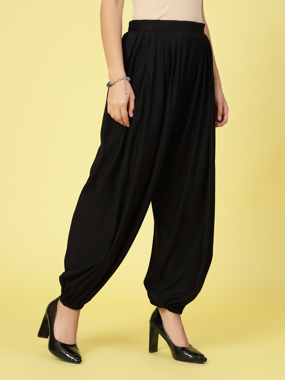 Women solid rayon loose fit salwar with pleated detail and elasticated waistband.