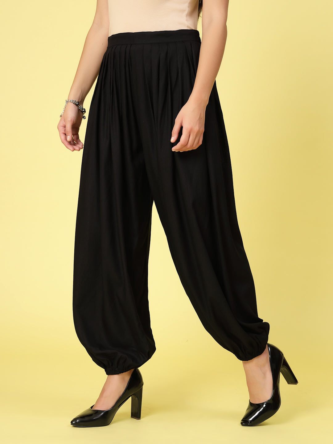 Women solid rayon loose fit salwar with pleated details and elasticated waistband.