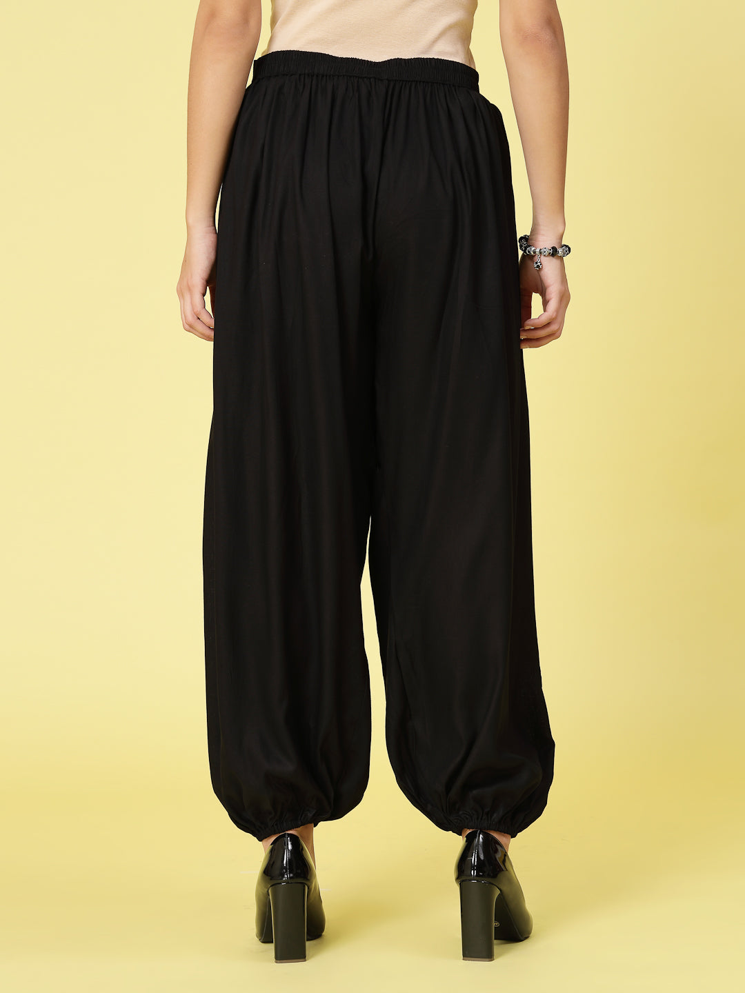 Women solid rayon loose fit salwar with pleated details and elastic waistband.