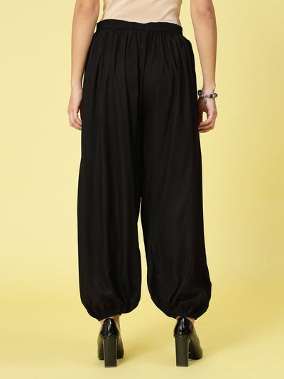 Women solid rayon loose fit salwar with pleated details and elastic waistband.