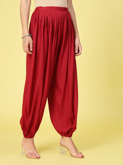 Women’s red solid rayon loose fit salwar with pleated details and elastic waistband.