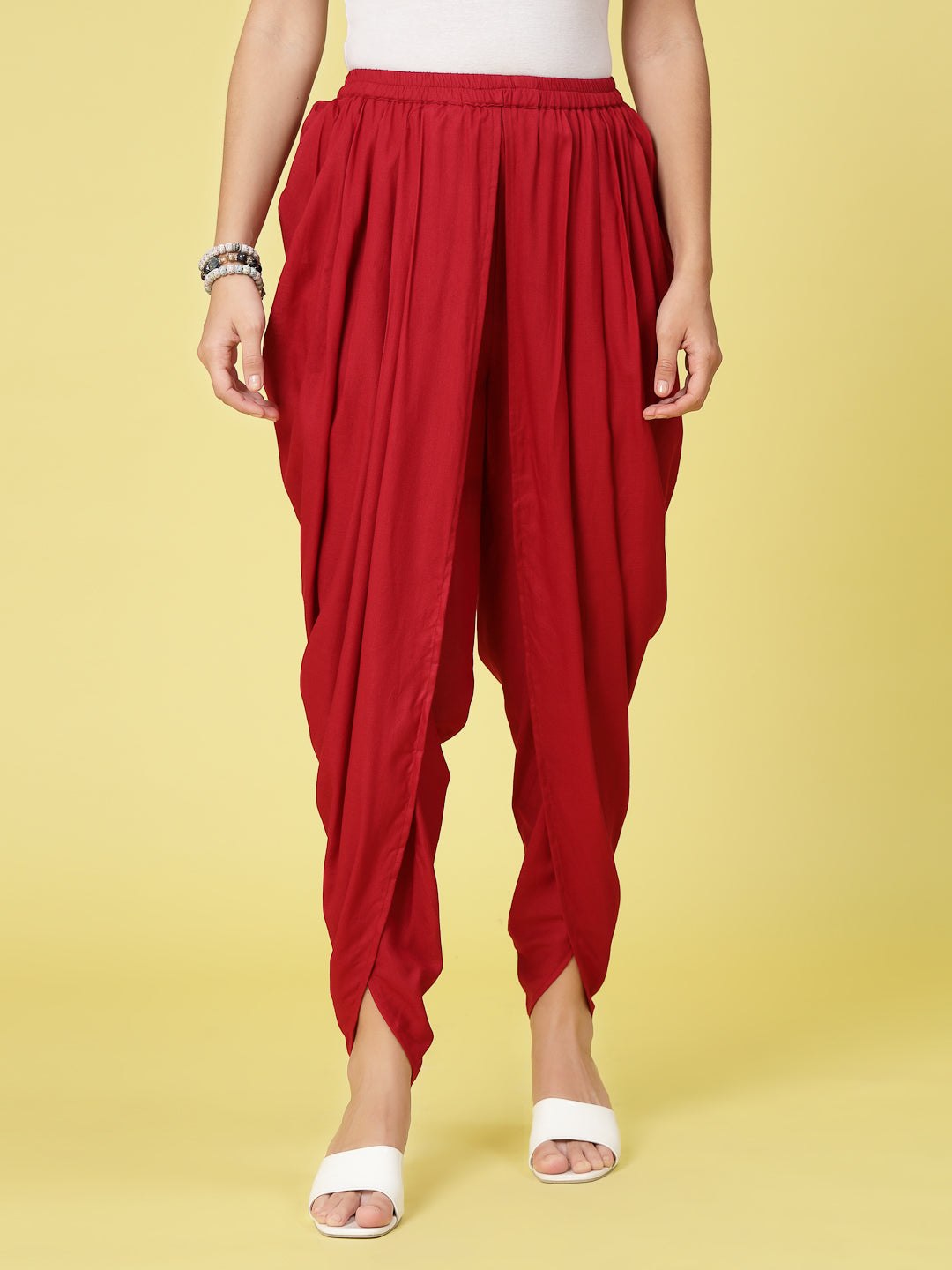 Women wearing red solid rayon dhoti salwar with pleated details and elasticated waistband.