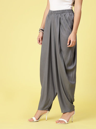Women wearing solid grey rayon dhoti salwar with elasticated waistband and curved ankle-length hemline.