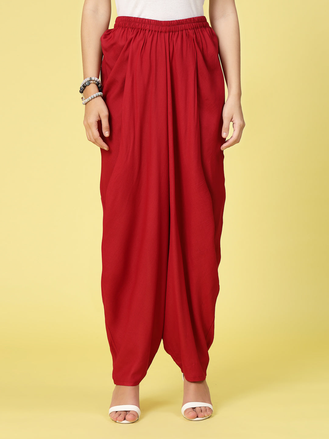 Women solid rayon dhoti salwar with elasticated waistband and curved ankle length hemline.