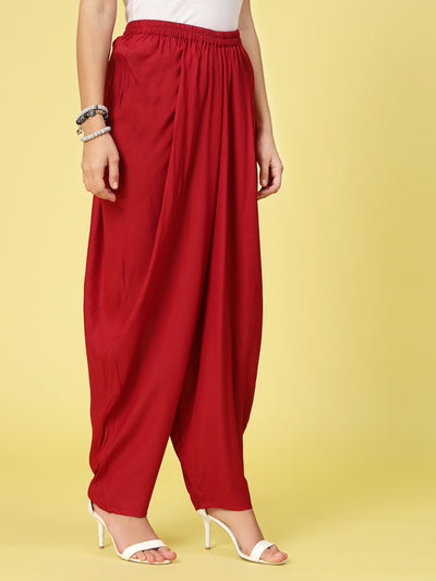 Women solid rayon dhoti salwar with elasticated waistband and curved hemline.