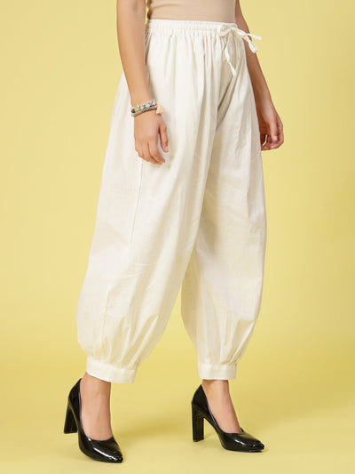 Off-White Solid Cotton Afghani Salwar with elasticated waistband and drawstring.