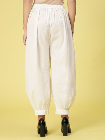 Off-White Solid Cotton Afghani Salwar with elastic waistband and drawstring.