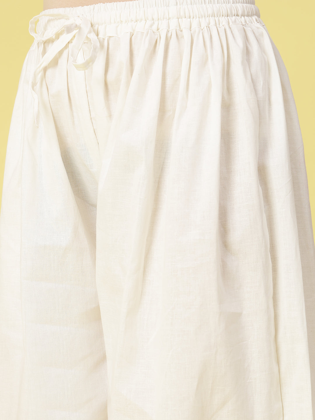 Off-White Solid Cotton Afghani Salwar with elasticated waistband and drawstring.