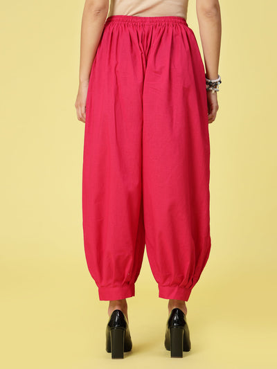 Magenta solid cotton Afghani salwar with elasticated waistband and drawstring.