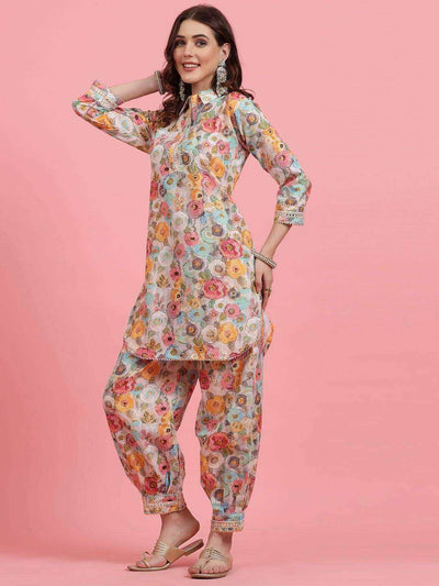 Women printed cotton co-ords with tunic and Afghani trousers, featuring floral embroidery, shirt collar, and three-quarter sleeves.