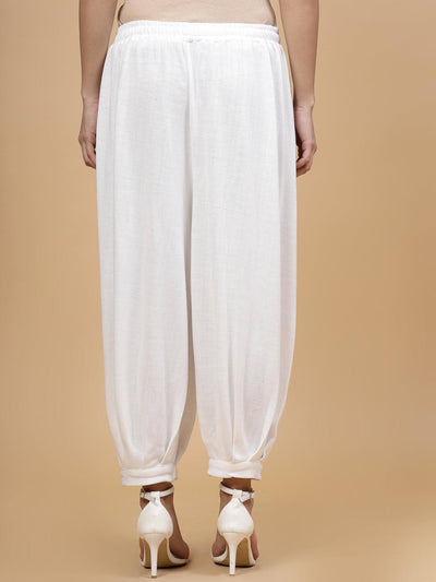 White solid woollen Afghani salwar with elasticated waistband and slip-on closure.