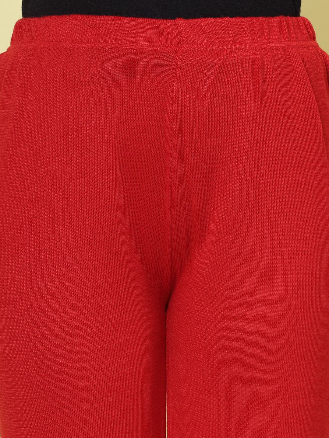 Red solid woollen palazzo with elastic waistband.