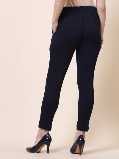 White and navy blue solid woollen trousers with elasticated waistband, side pockets, and slip-on closure.
