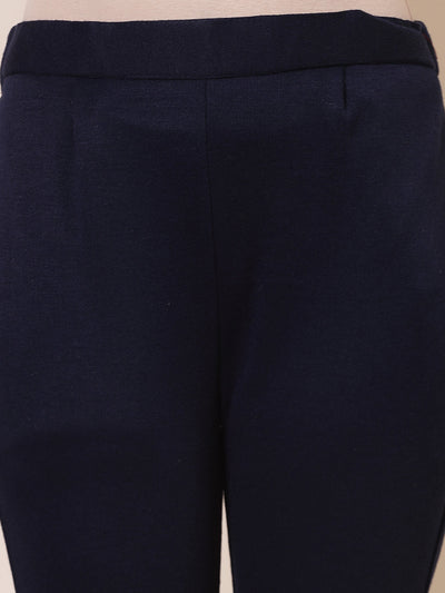 White and navy blue solid woollen trousers with elasticated waistband and side pockets.