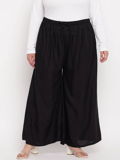 Black Solid Rayon Jumbo Sharara with elasticated waistband and drawstring.