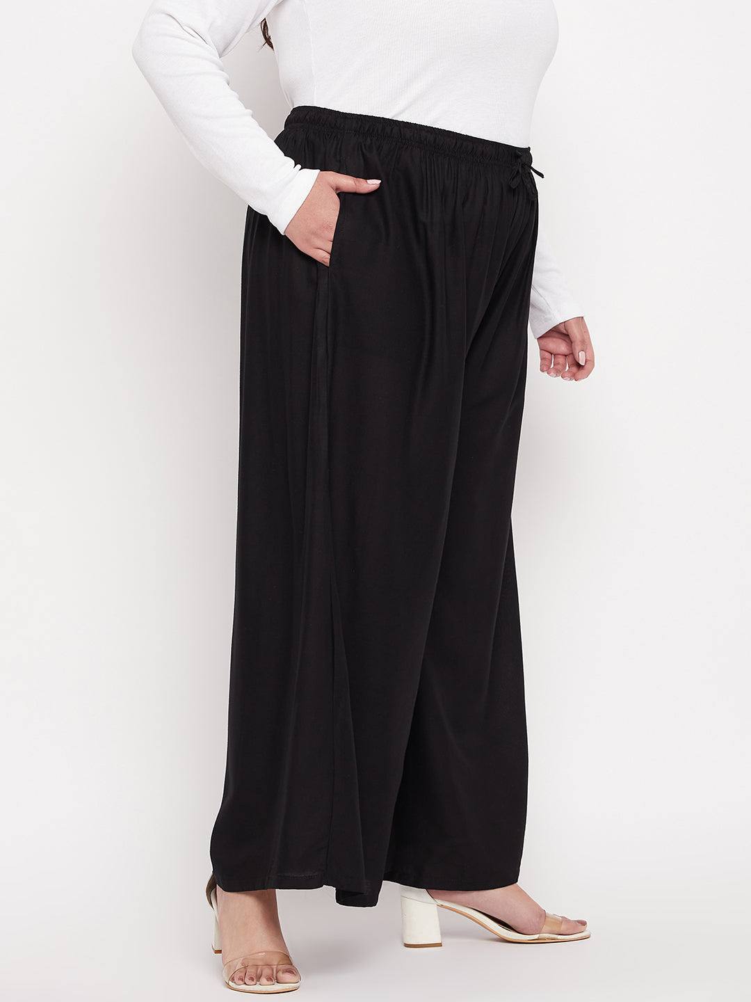 Black solid rayon jumbo sharara with elasticated waistband and drawstring.