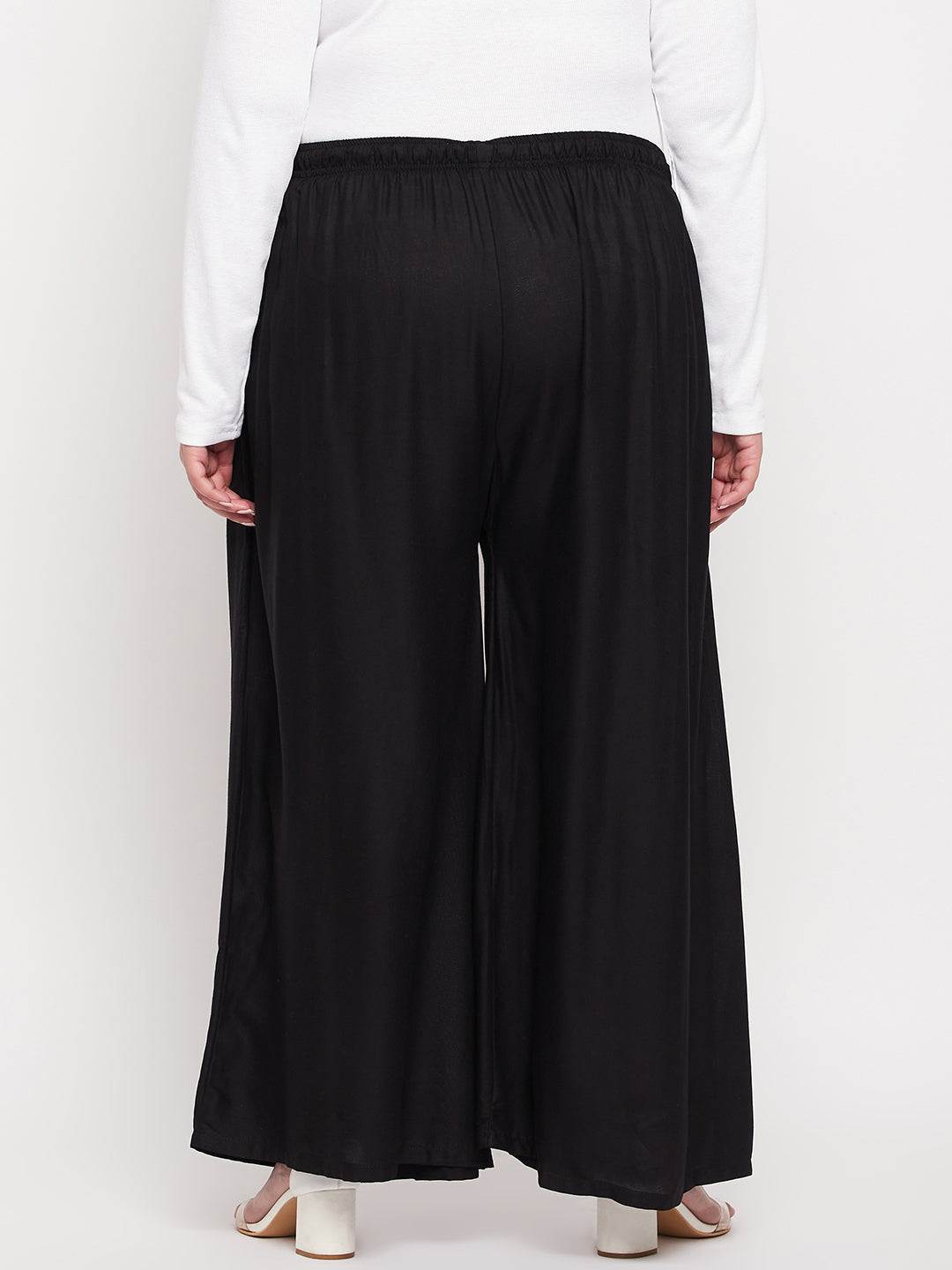Black solid rayon jumbo sharara with elasticated waistband and drawstring.
