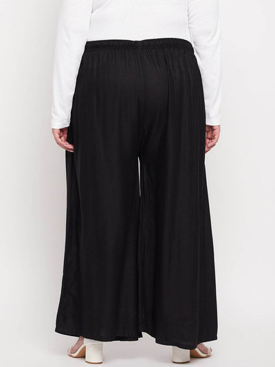Black solid rayon jumbo sharara with elasticated waistband and drawstring.