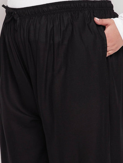 Black solid rayon jumbo sharara with elastic waistband and drawstring.