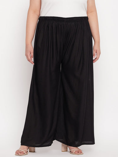Black solid rayon palazzo with elasticated waistband and drawstring.