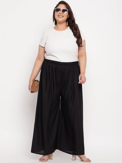 Black solid rayon palazzo with elasticated waistband and drawstring.