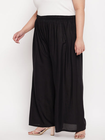 Black solid rayon palazzo with elasticated waistband and drawstring.