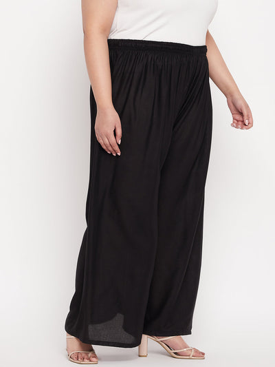 Black solid rayon palazzo with elasticated waistband and drawstring.