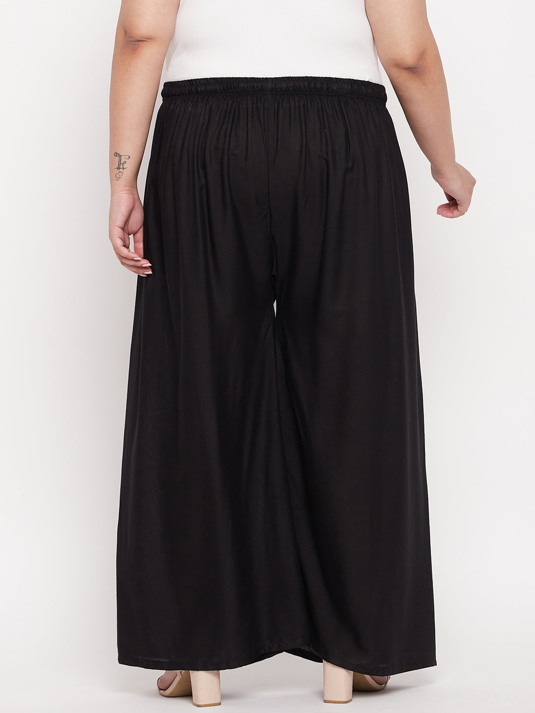 Black solid rayon palazzo with elasticated waistband and drawstring.