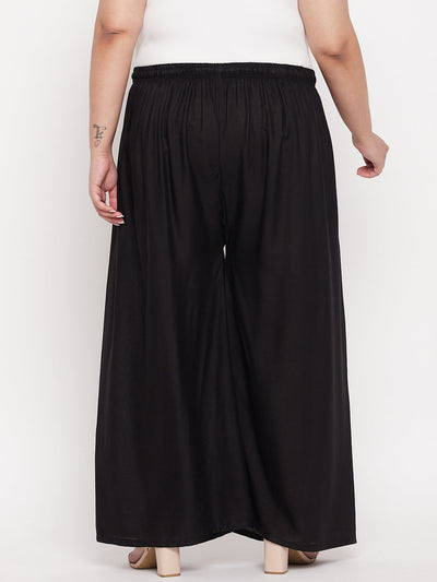 Black solid rayon palazzo with elasticated waistband and drawstring.