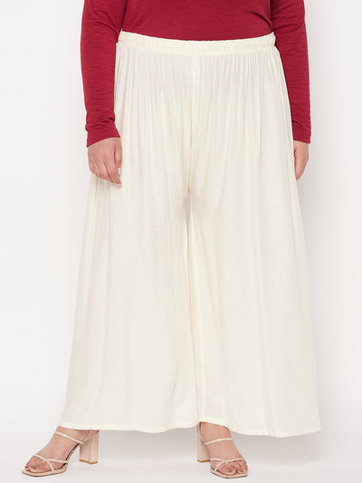 Off-White Solid Rayon Palazzo with elasticated waistband and drawstring.