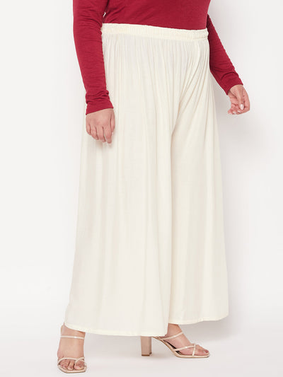 White solid rayon palazzo with elasticated waistband and drawstring.