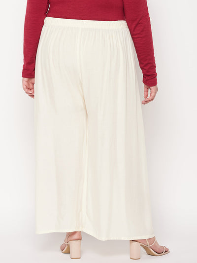Off-White solid rayon palazzo with elasticated waistband and drawstring.