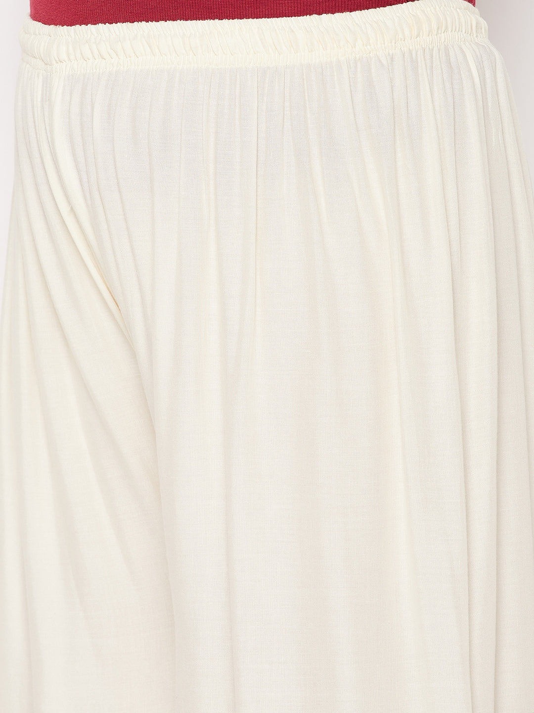 Off-white solid rayon palazzo with elasticated waistband and drawstring.