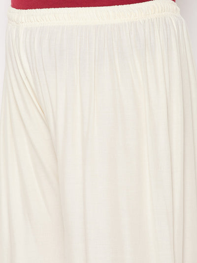 Off-white solid rayon palazzo with elasticated waistband and drawstring.