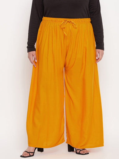 Mustard solid rayon palazzo with elastic waistband and drawstring.