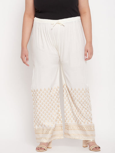 Cream printed rayon palazzo with printed hem and elastic waistband.