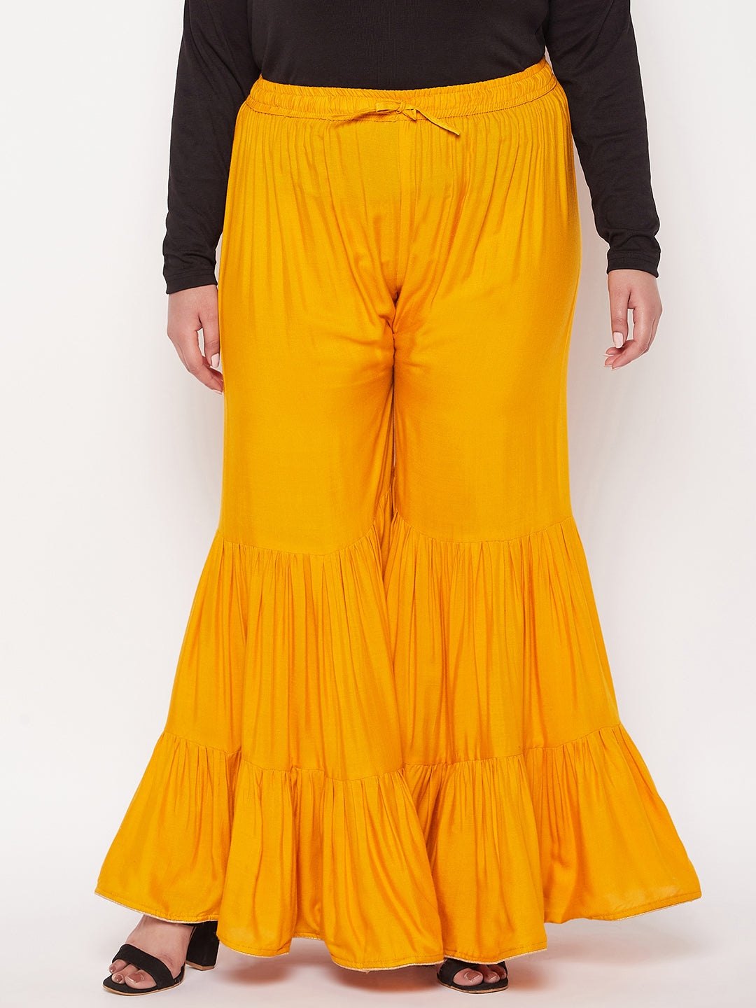 Mustard solid rayon flared gharara with elasticated waistband and drawstring.
