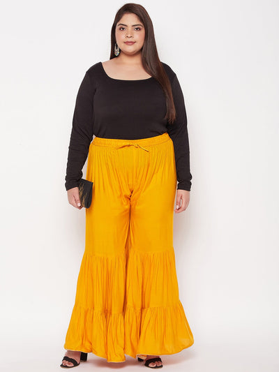 Mustard solid rayon flared gharara with elasticated waistband.