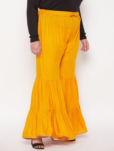 Mustard solid rayon flared gharara with elasticated waistband and drawstring.