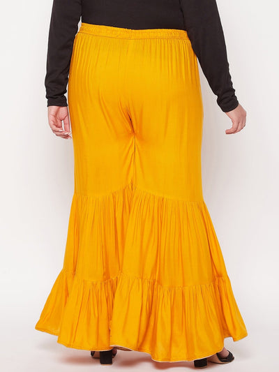 Mustard solid rayon flared gharara with elastic waistband and drawstring.