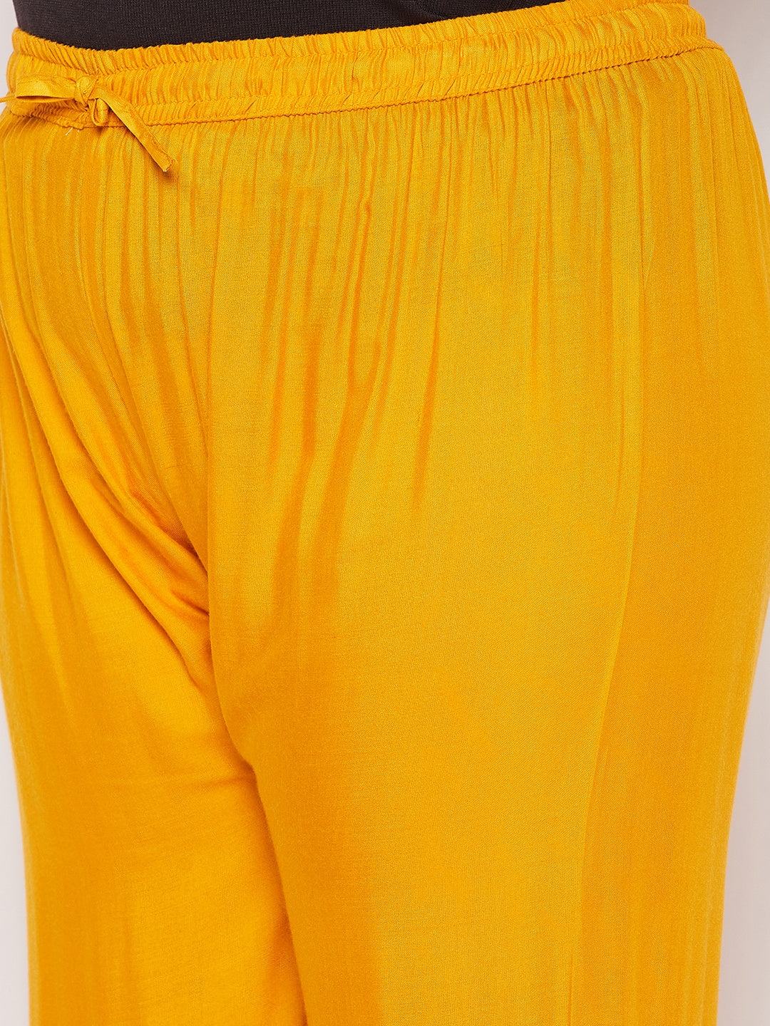 Mustard solid rayon flared gharara with elastic waistband and drawstring.