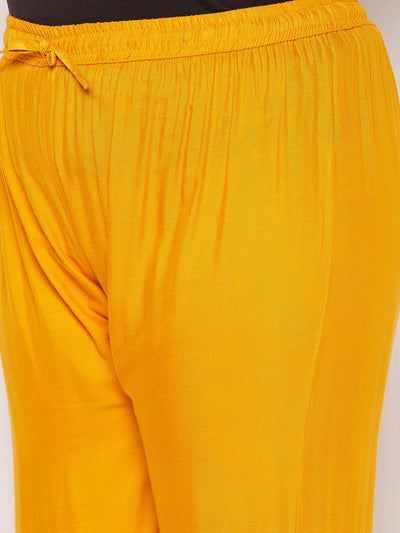 Mustard solid rayon flared gharara with elastic waistband and drawstring.