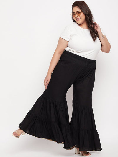 Black solid rayon flared gharara with elasticated waistband and drawstring.